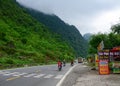 Vehicle driving on rural road with moutain background