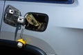 Vehicle with fuel door open symbolizing rising cost of fuel.