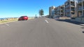 Vehicle POV, driving along The Esplanade in Glenelg, South Australia.