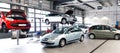 vehicles in a car repair shop for the repair with lifting platform Royalty Free Stock Photo