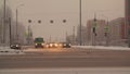 Vehicles driving on crossroad at cold winter day in urban city