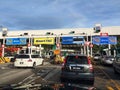 Vehicles entering highway toll canopy in Malaysia.