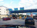 Vehicles entering highway toll canopy in Malaysia.