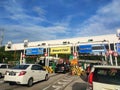 Vehicles entering highway toll canopy in Malaysia.