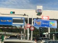 Vehicles entering highway toll canopy in Malaysia.