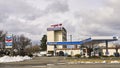 Vehicles fueling up at a corner Chevron gas station with a hotel in the background on a winter's day Royalty Free Stock Photo