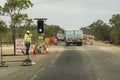 Vehicles Moving Through Green Light Watched By Worker At Road Construction Site Royalty Free Stock Photo