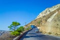 Vehicles moving on narrow winding road Santorini island Greece