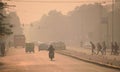 Vehicles and people moving in the road amidst heavy smog in Delhi