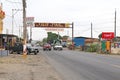 Vehicles and people on one of the main roads through the city of