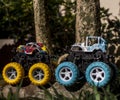 Monster car toys standing on stone and grass.