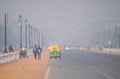 Vehicles traveling on the road amidst heavy smog.