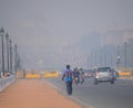 Vehicles traveling on the road amidst heavy smog.