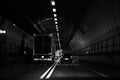 Vehicles travelling through Dartford tunnel at night.