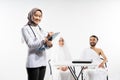 A veiled doctor carries a clipboard with a prospective congregation