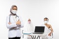 Veiled doctor in mask with thumbs up while standing