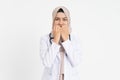 veiled female doctor wearing white coat uniform covering her mouth with both hands out of fear