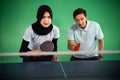 Veiled female and male ping pong players ready to play Royalty Free Stock Photo