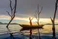 Veiled Islamic muslim woman wearing a burka standing and praying on the boat Royalty Free Stock Photo