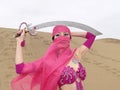 Veiled woman and sabre at desert