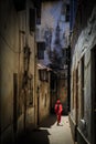 Veiled woman walking through a narrow street Royalty Free Stock Photo