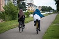 veiled women on bicycle on bike lane in border water
