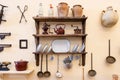 Vejer de la Frontera, CÃÂ¡diz, Spain - June 14, 2021: Old kitchen utensils on wooden shelves and attached to the wall of a typical