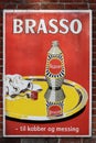 Old style tin advertising board in danish for Brasso metal polish on a wall