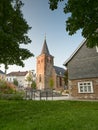 Velbert, Germany - August 23, 2021: Old Evangelical Church in the city center surrounded by flowers and greenery during sunset