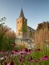 Velbert, Germany - August 23, 2021: Old Evangelical Church in the city center surrounded by flowers and greenery during sunset