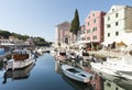 VELI LOSINJ, CROATIA, AUGUST 31, 2011: View of the historic harbor of Veli LoÃÂ¡inj with boats, St. Antun Opat Pustinjak church