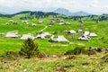 Big Pasture Plateau in the Kamnik Alps, Slovenia. Mountain cottage hut or house on green hill. Alpine meadow landscape. Farm