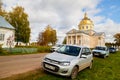 Velikoretskoe, Russia - September 15, 2019: Traditional russian church with domes and cars near it in a summer or autumn day Royalty Free Stock Photo