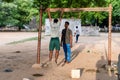 Young Indian boys exercising and doing pull ups on a metal bar in an outdoor