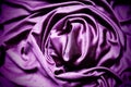 Velour fabric, similar to silk. Textiles in a folds, beautiful waves, twisted into a circle. Purple, pink, magenta