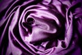 Velour fabric, similar to silk. Textiles in a folds, beautiful waves, twisted into a circle. Purple, pink, magenta