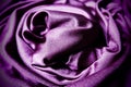 Velour fabric, similar to silk. Textiles in a folds, beautiful waves, twisted into a circle. Purple, pink, magenta