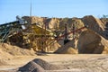 Velt conveyors and a piles of rubble in gravel quarry, crushed sand in different sizes