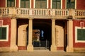 Veltrusy Rococo castle, Romantic baroque chateau red with white windows in sunny autumn day, entrance with columns and bas-relief