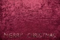 Velvet cloth wine red background with merry christmas text Royalty Free Stock Photo