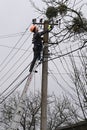 Velyka Vilshanytsia, Ukraine - March 9, 2023: A worker repairs a power line following a Russian missile strike in Lviv region