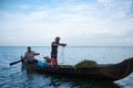 Vembanad lake, Kerala - 20 october 2019: portrait of an indian fisherman on a boat fishing with nets, a symbol of indian economy