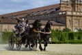 A beautiful carriage crosses the gardens.