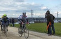 Three Cyclists on a Dirty Road - Paris-Nice 2016