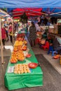 Vendor behind table of fresh fruit at local farmers market