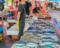 Vendor behind table of fresh fruit at local farmers market