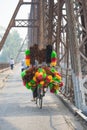 Vendor bike with full loaded of feather duster on Long Bien old metal bridge, Hanoi Royalty Free Stock Photo