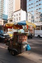 Vendor cart with umbrellas in New York City selling sausages