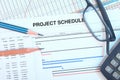 Project schedule With gant chart, eyeglasses, pencil, pen and calculator. Royalty Free Stock Photo