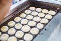 Vendor Cooking Khanom Kai Chinese Egg Cake, traditional Thai baked sweet dessert mini castella cake made of starch, flour, egg,